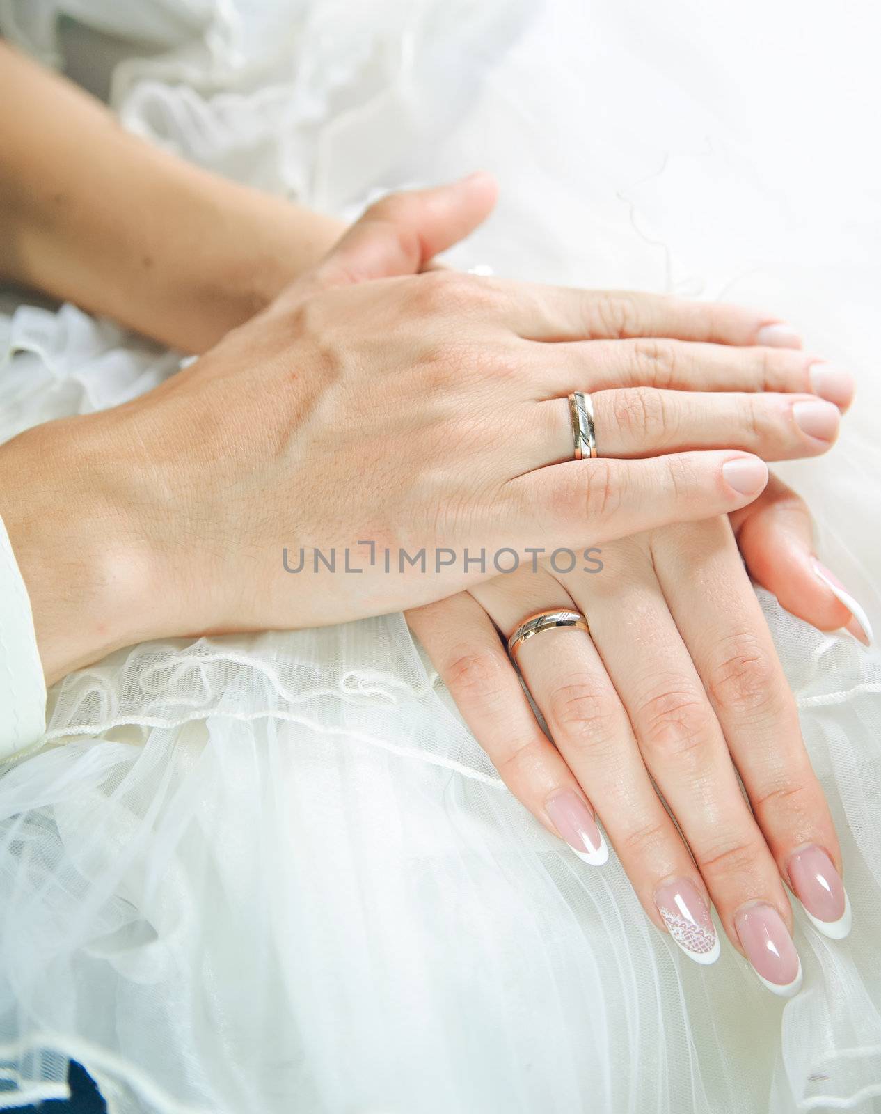 bridegroom hands on a bride hands. Love and care
