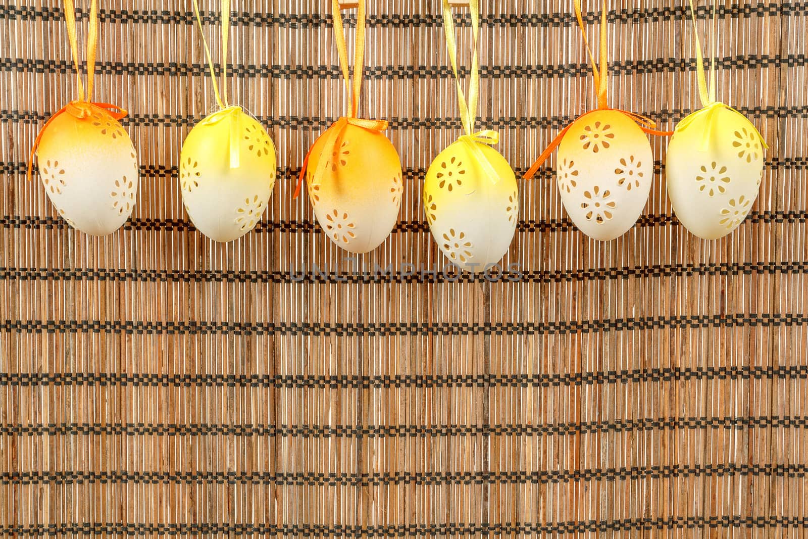 Bright color easter eggs with bows on wooden background