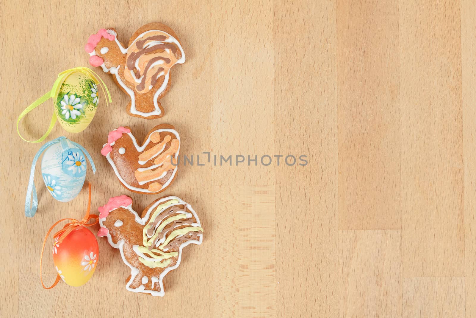 Easter ginger breads and painted egg on wooden background