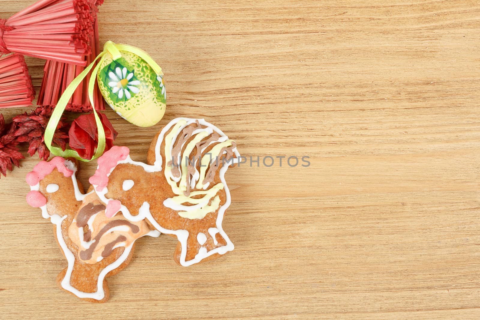 Easter ginger breads and painted egg on wooden background