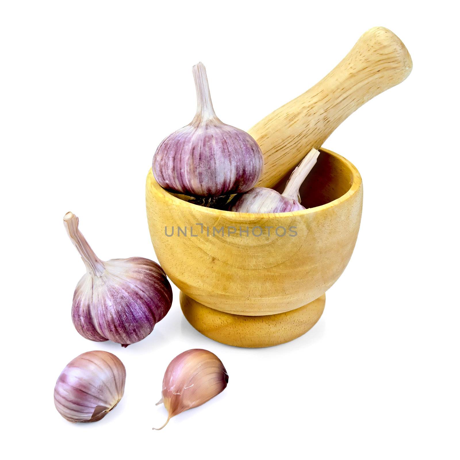 Whole and cloves of garlic bulbs in a wooden mortar and on the table isolated on white background