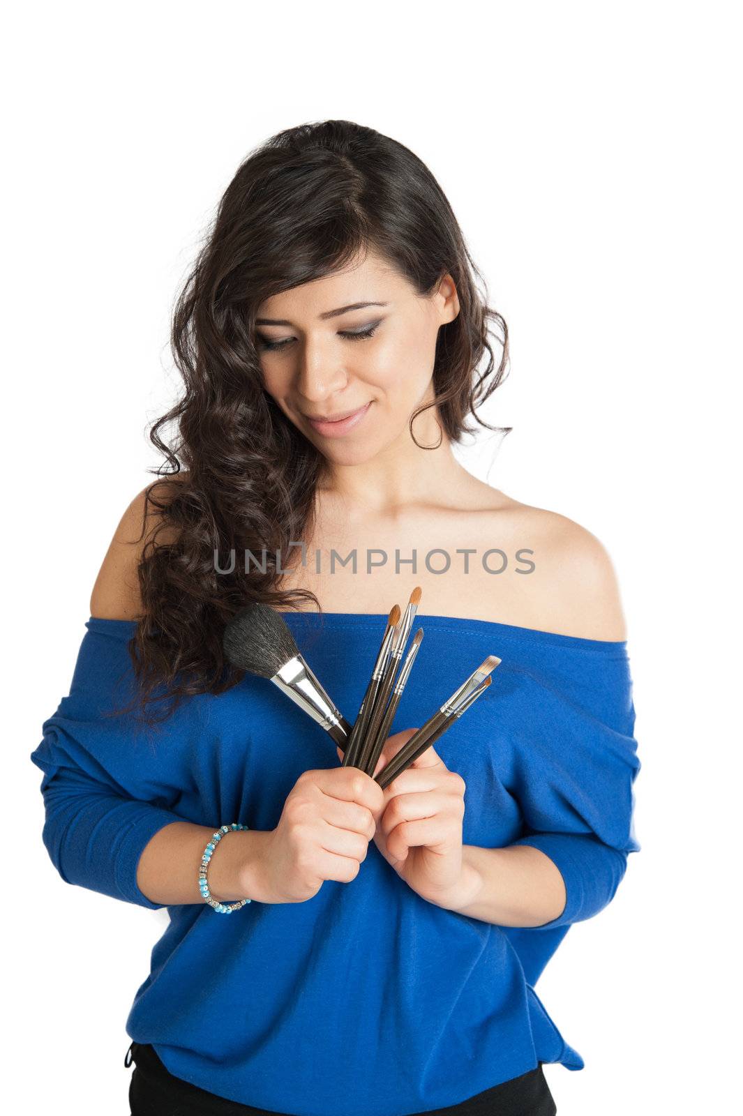 beautiful brunette holding a makeup brush