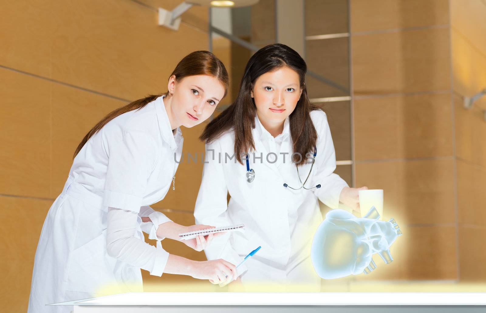 two doctors stand near glowing table discussing. projected objects on a desk