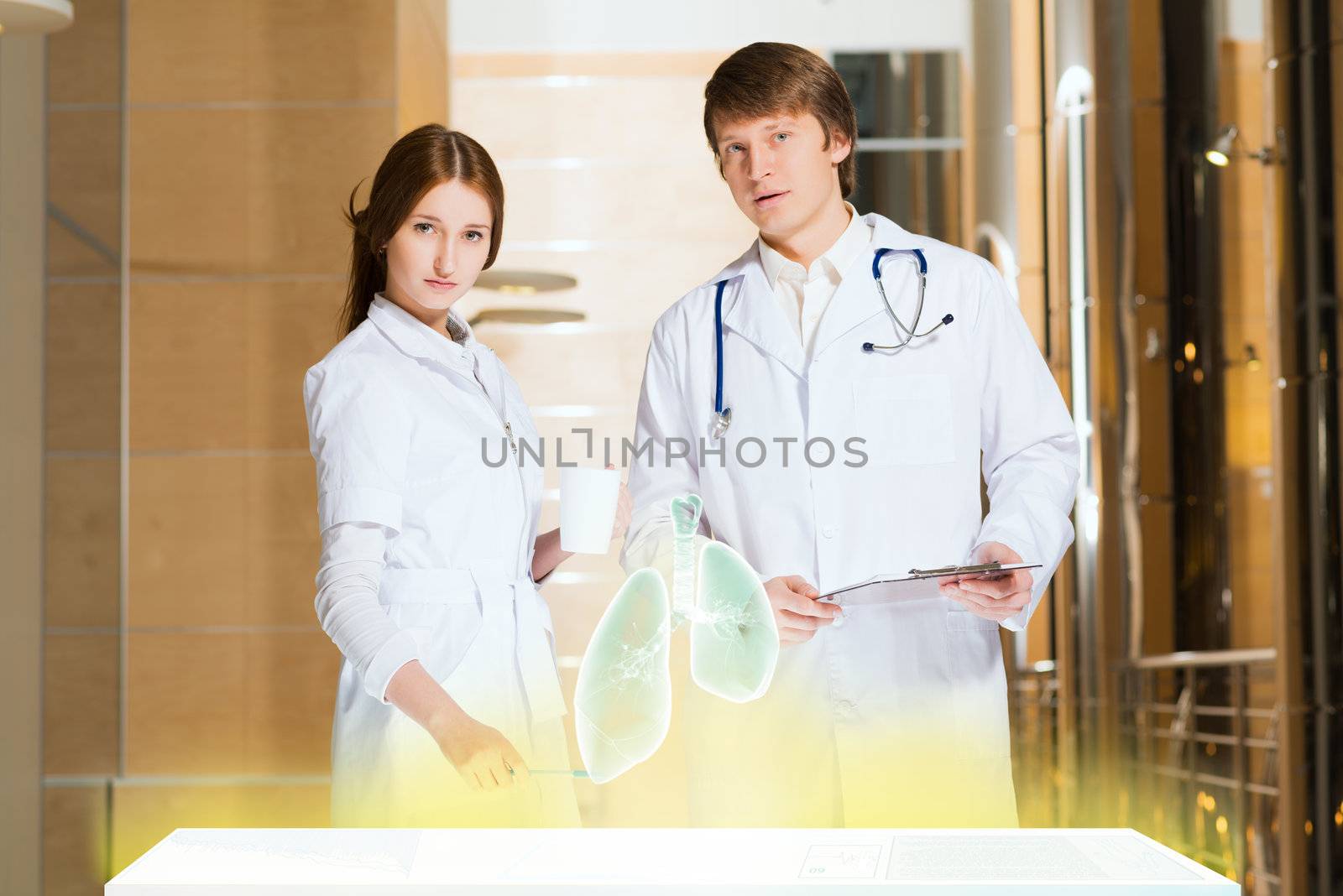 two doctors stand near glowing table discussing. projected objects on a desk