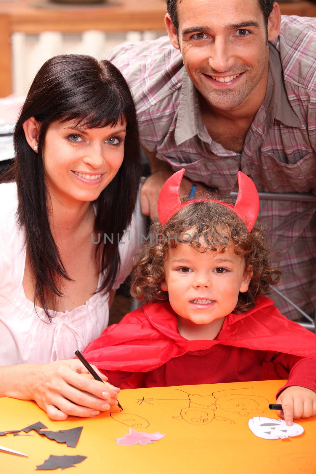 parents and a little boy dressed in devil