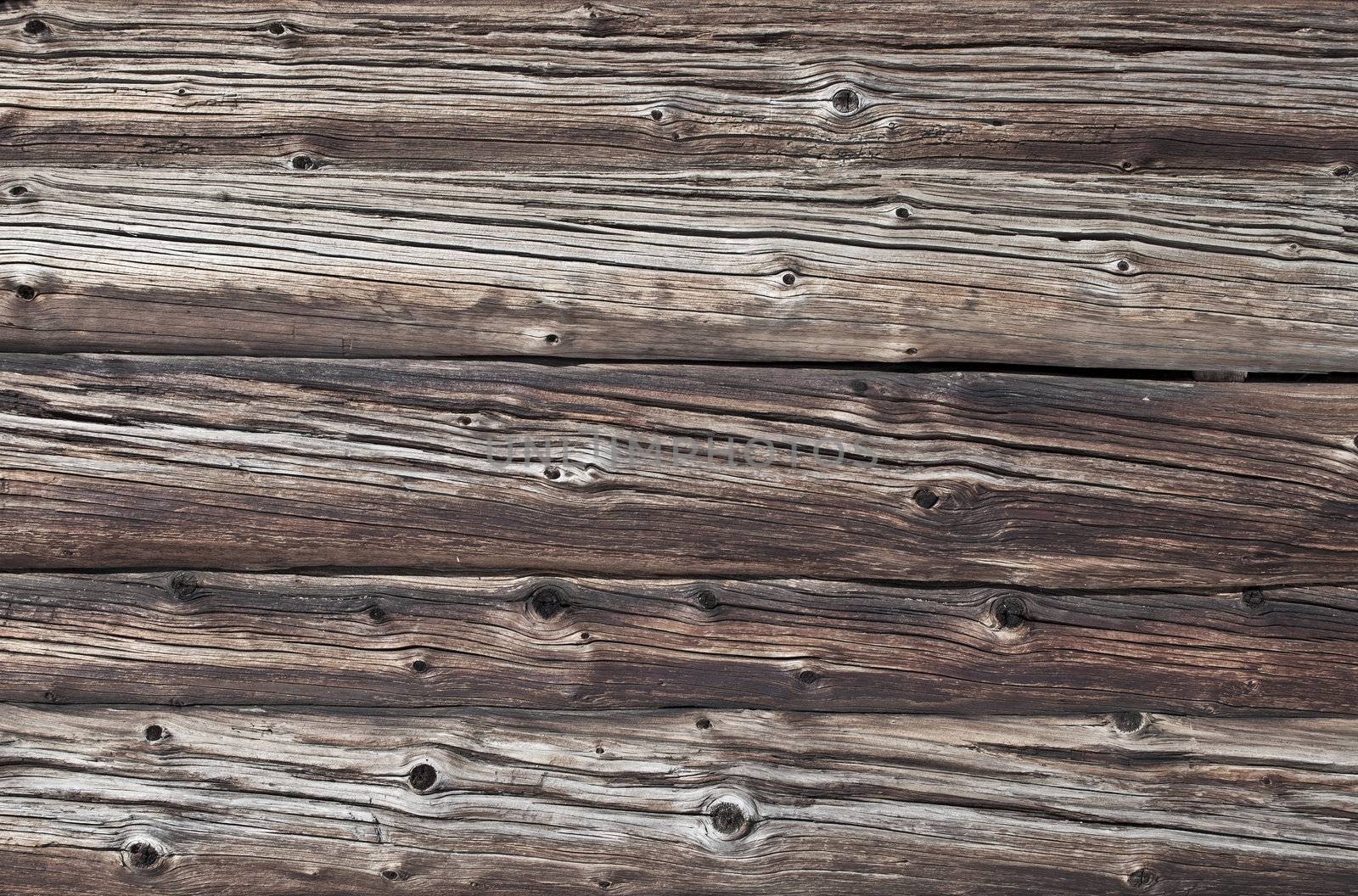 Fragment of old weathered log walls