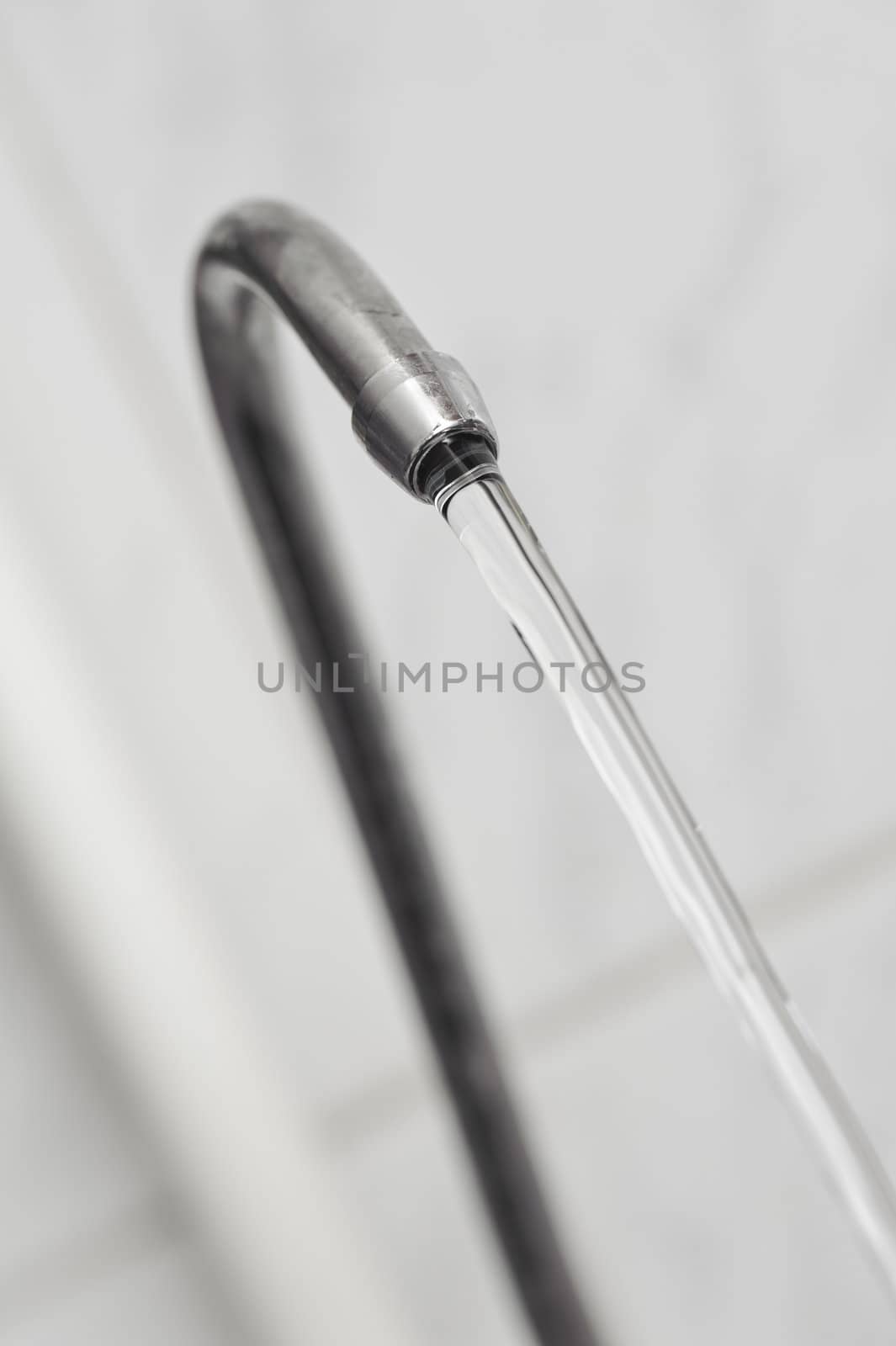 kitchen tap from blur backgrounds. flow pure water