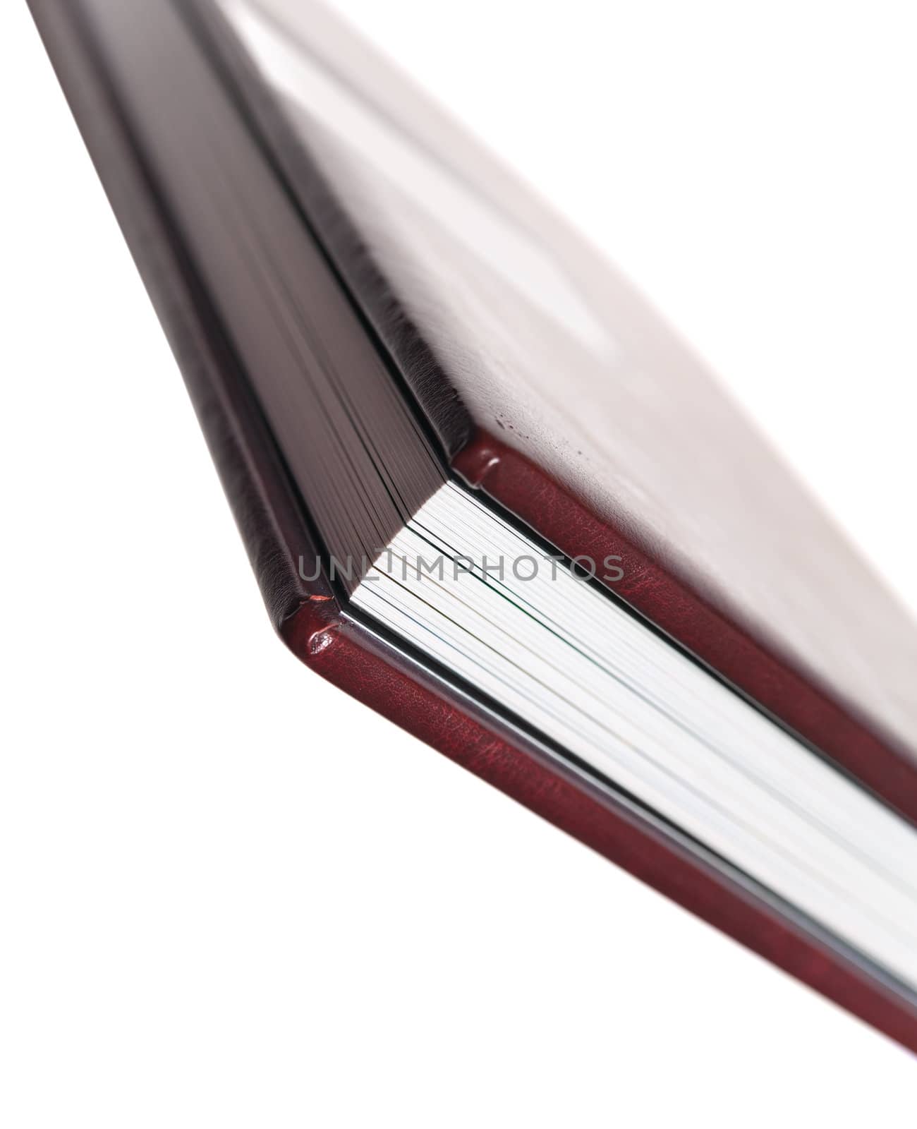 side view of book with leatherette cover on white backgrounds by docer2000