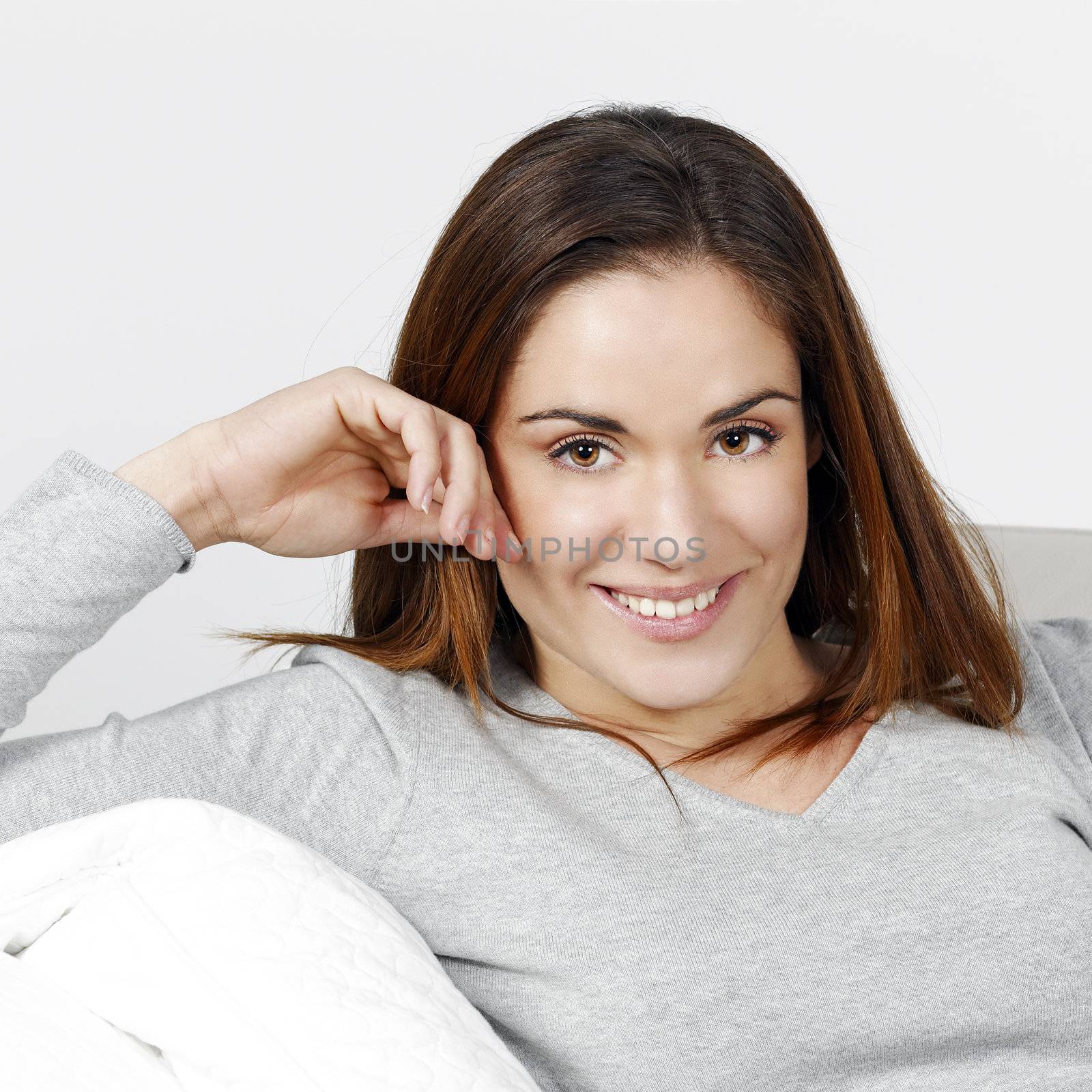 Young and beautiful woman alone on the sofa 