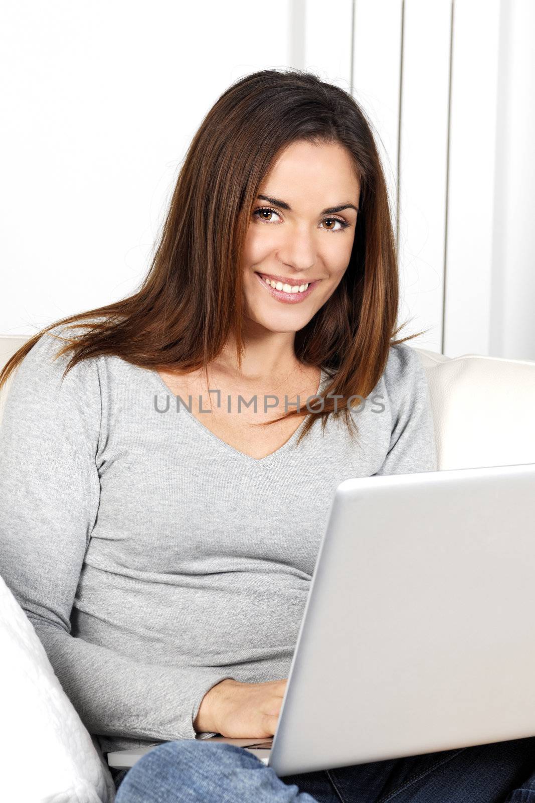 beautiful woman using laptop on sofa by vwalakte