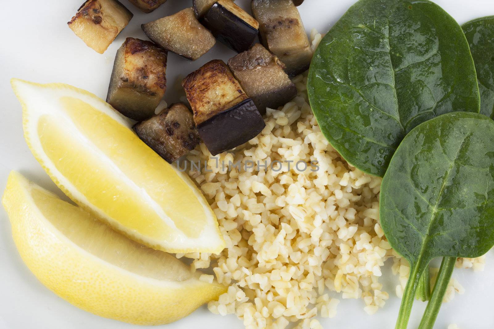 Fresh vegetable ingredients with spinach, eggplant/aubergine, lemon and bulgar