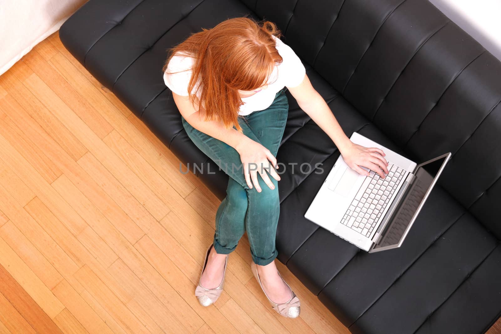 A young, brazilian woman surfing on the Internet with a Laptop.  