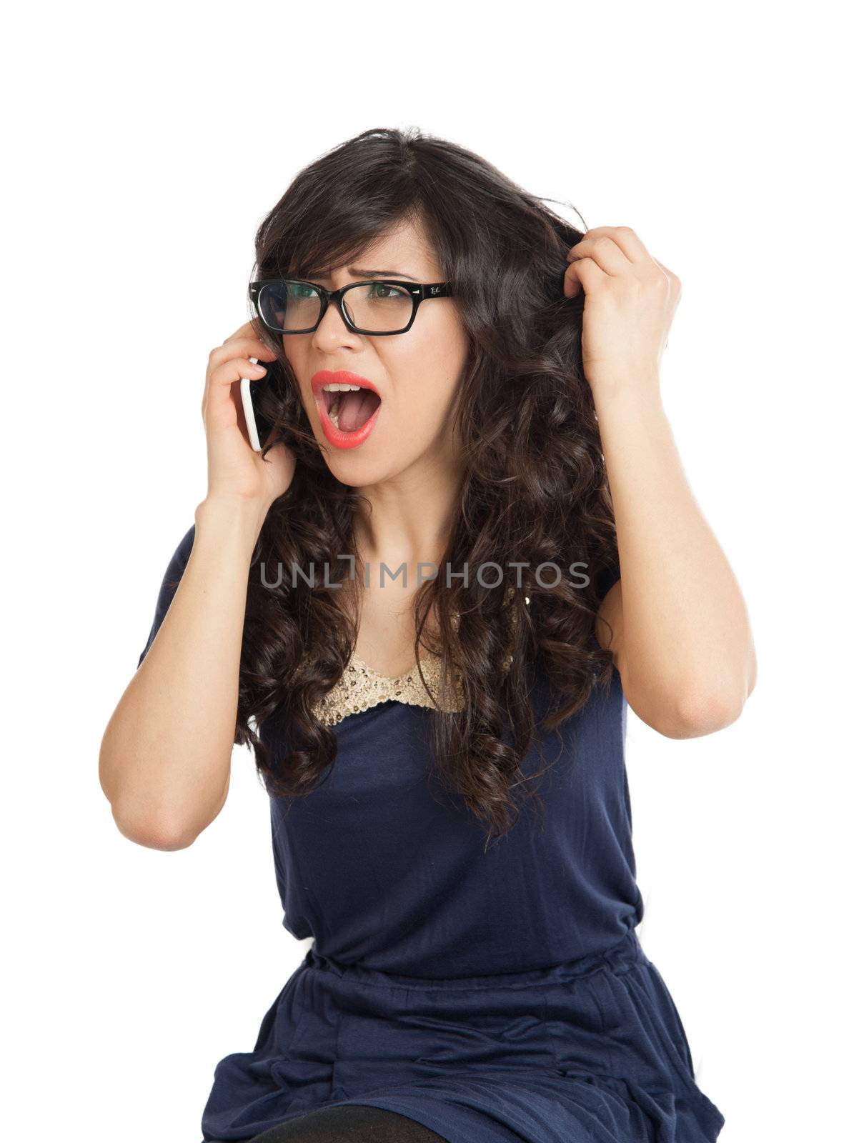 Beautiful woman in glasses shouts displeasure in a mobile phone