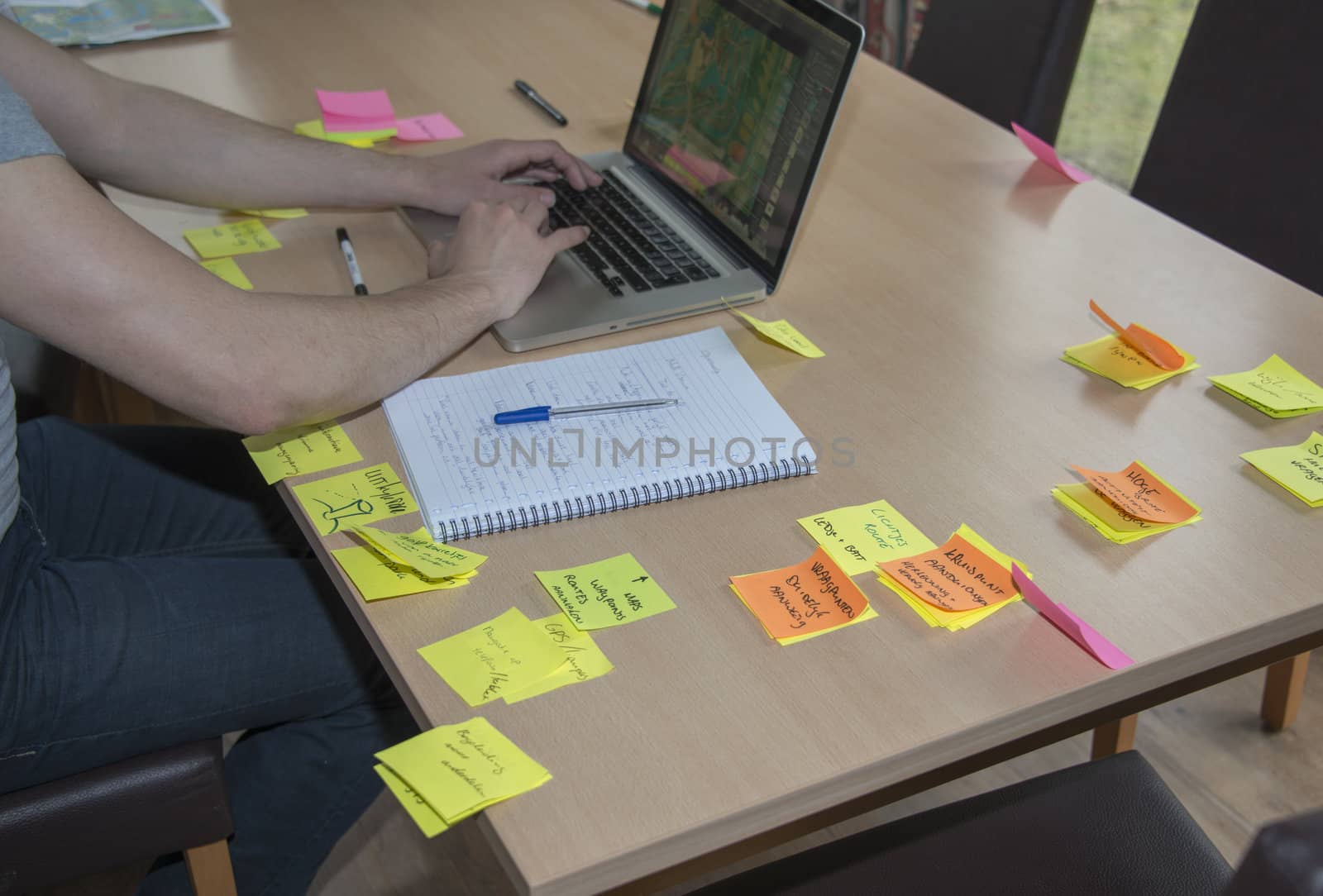 student busy with problem solving on table with note marks and computer
