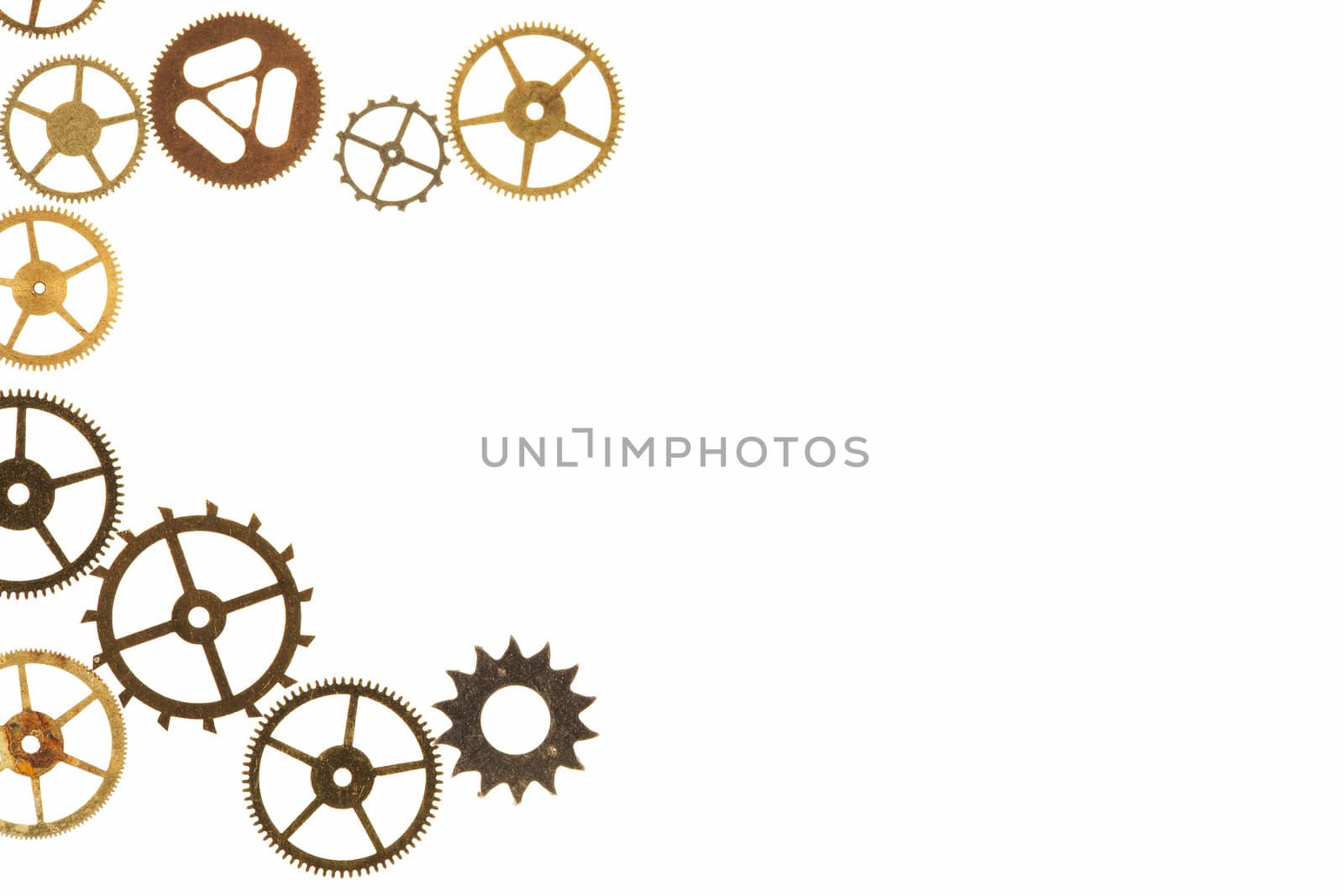 Cogs and other watch parts isolated on white background with copy space.