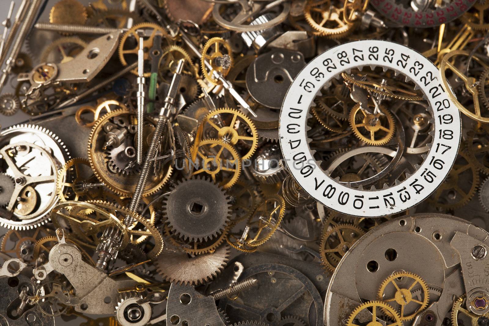 Pile of watch parts with date ring on top