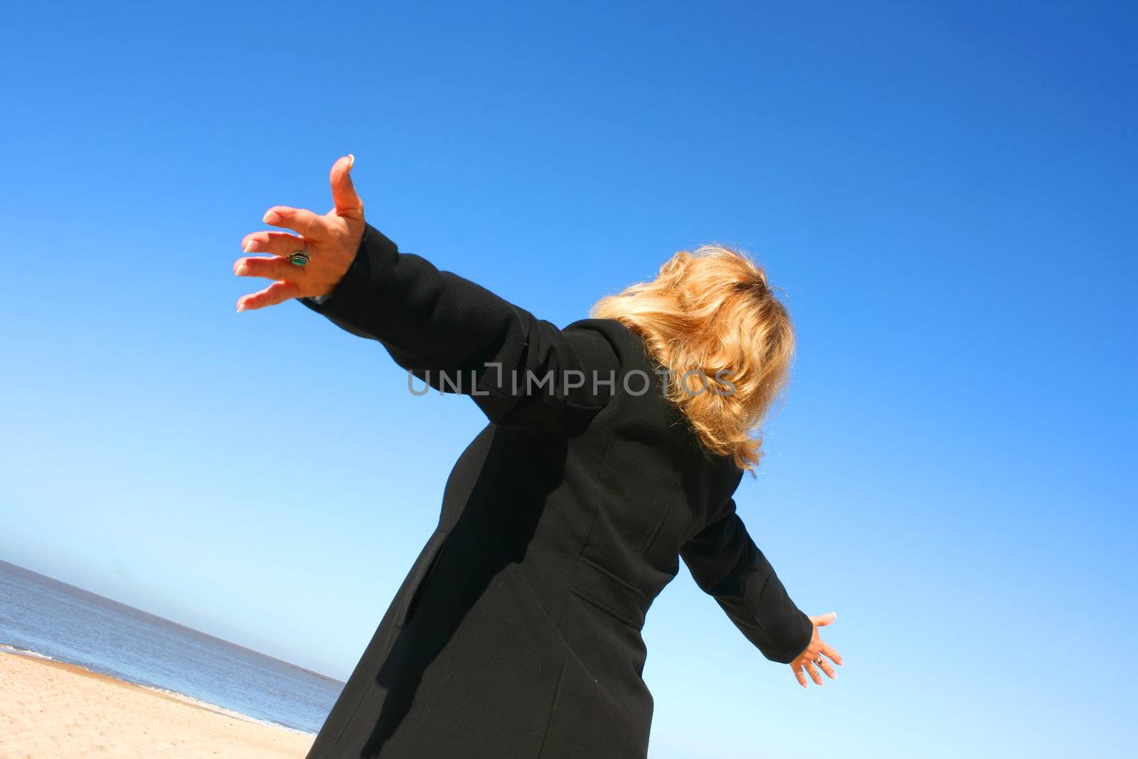 Portrait of a mature woman enjoying the sunlight on a beach.