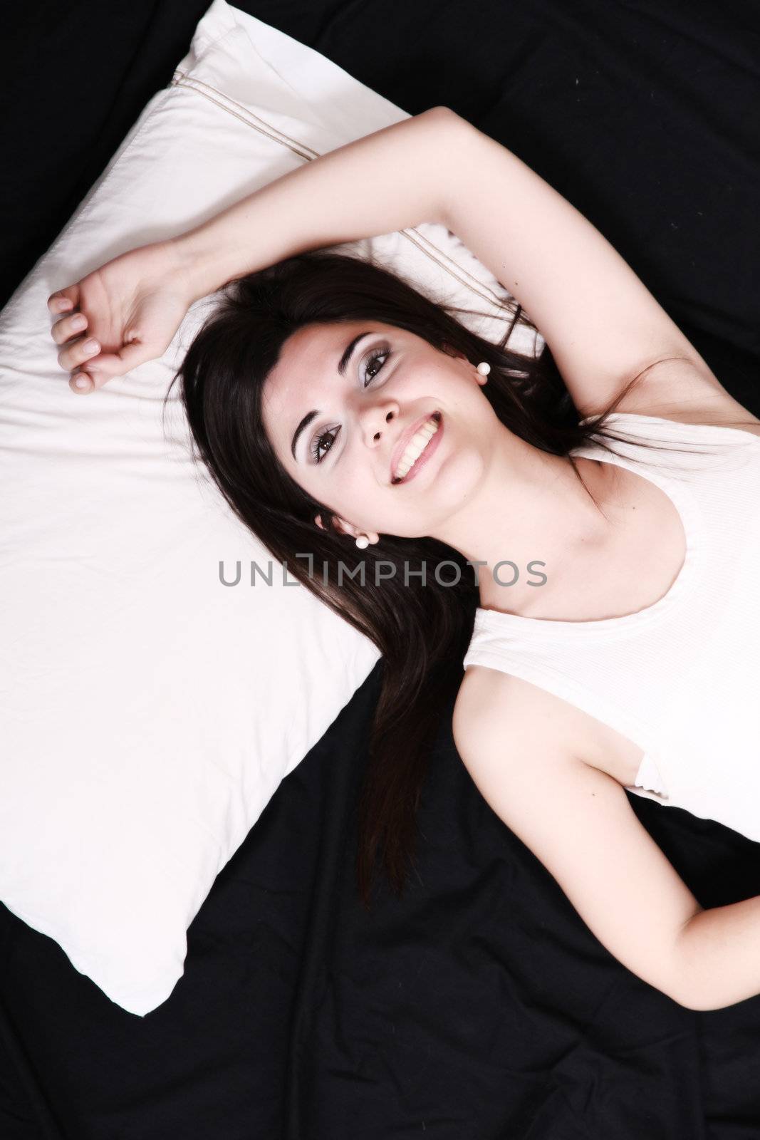 A young hispanic Woman sleeping on the Bed.