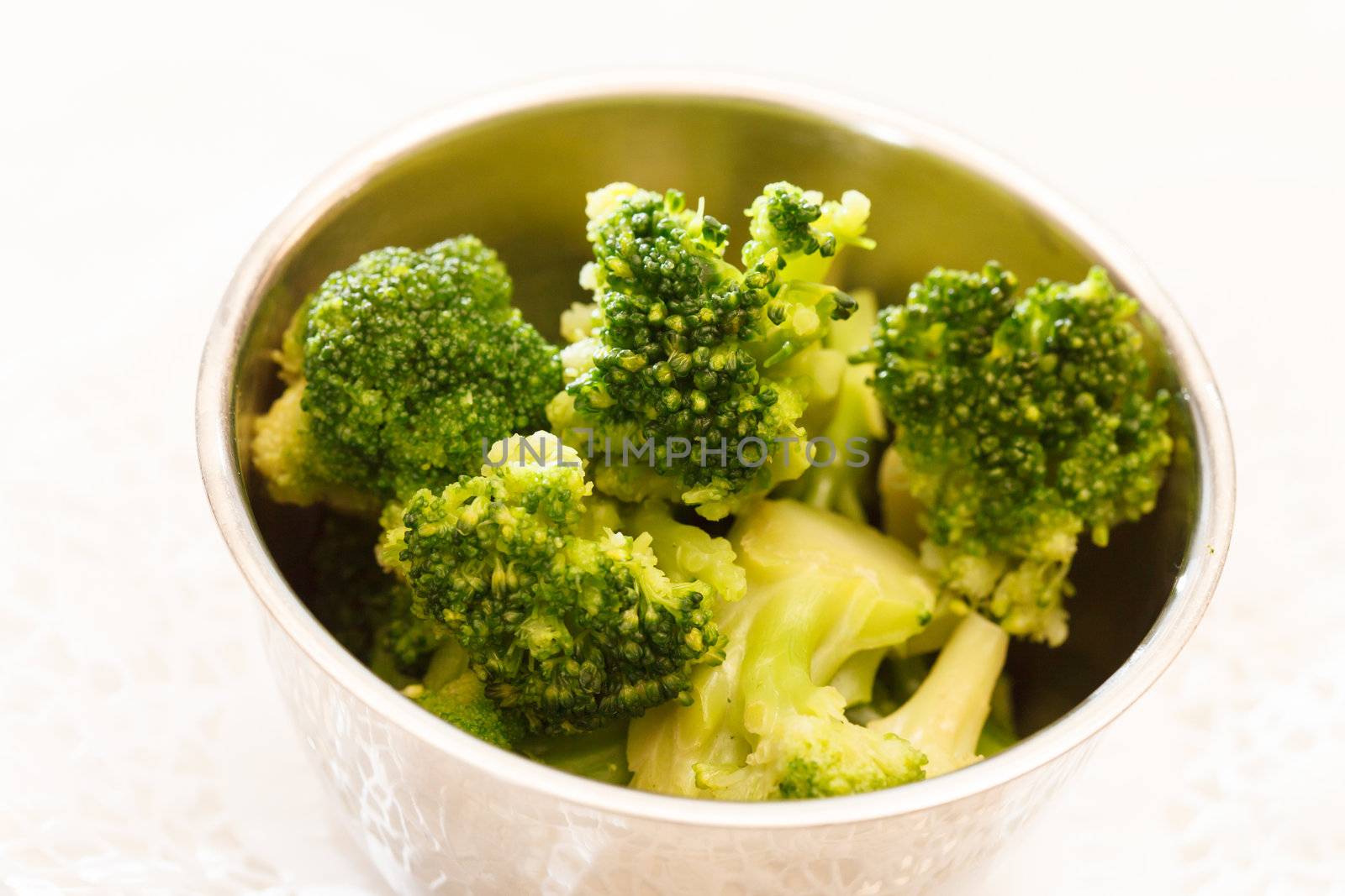 Steamed broccoli in a bowl  by shebeko
