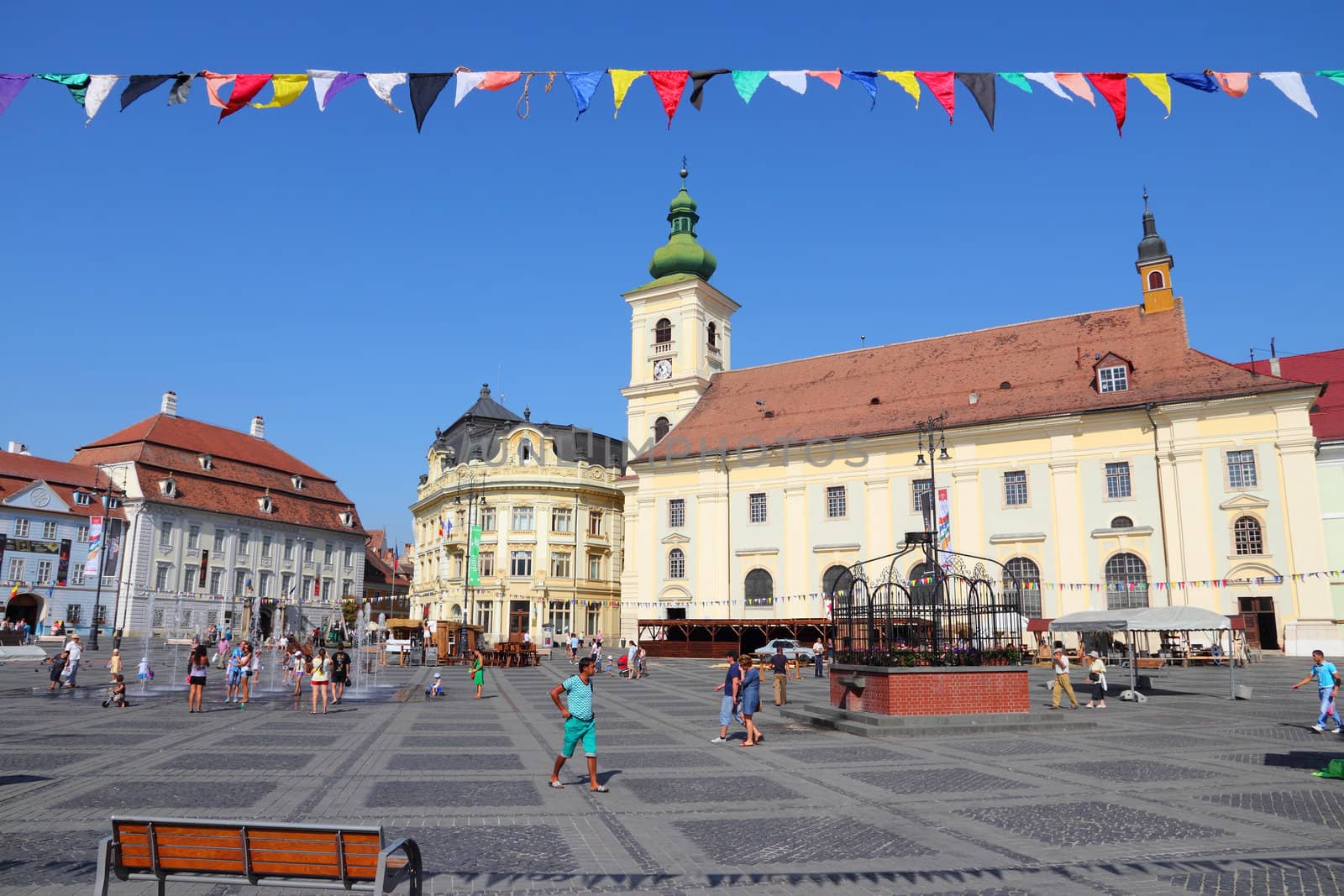 SIBIU, ROMANIA - AUGUST 24: Tourists visit main square on August 24, 2012 in Sibiu, Romania. Sibiu's tourism is growing with 284,513 museum visitors in 2001 and 879,486 visitors in 2009.