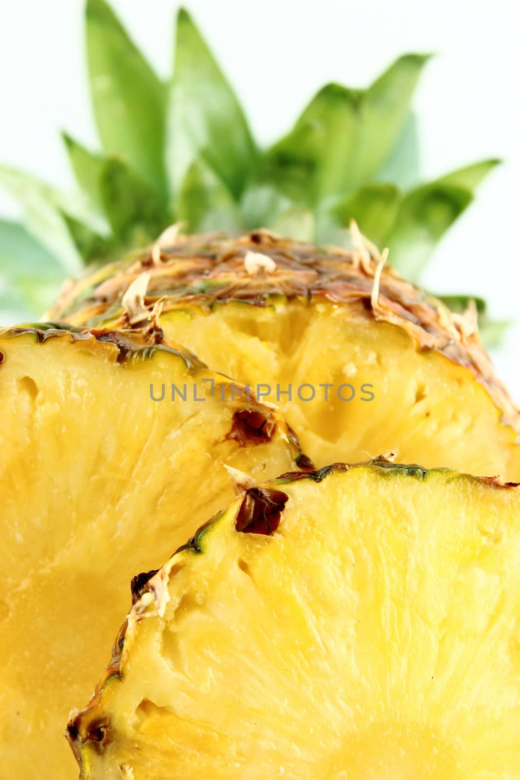 ripe pineapple with slices isolated on white background