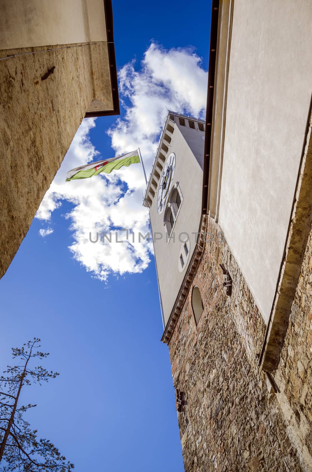 Clock tower of Ljubljana castle with town flag.