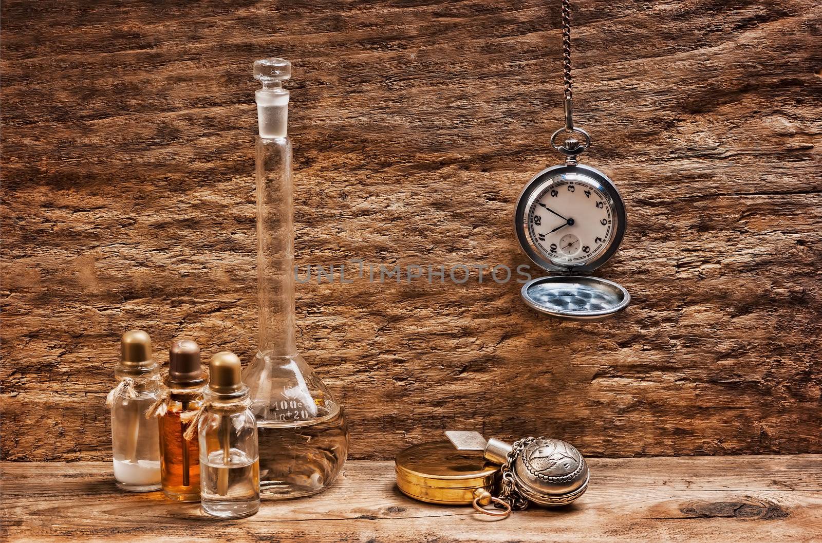 Vials with essential oils against the old wooden walls