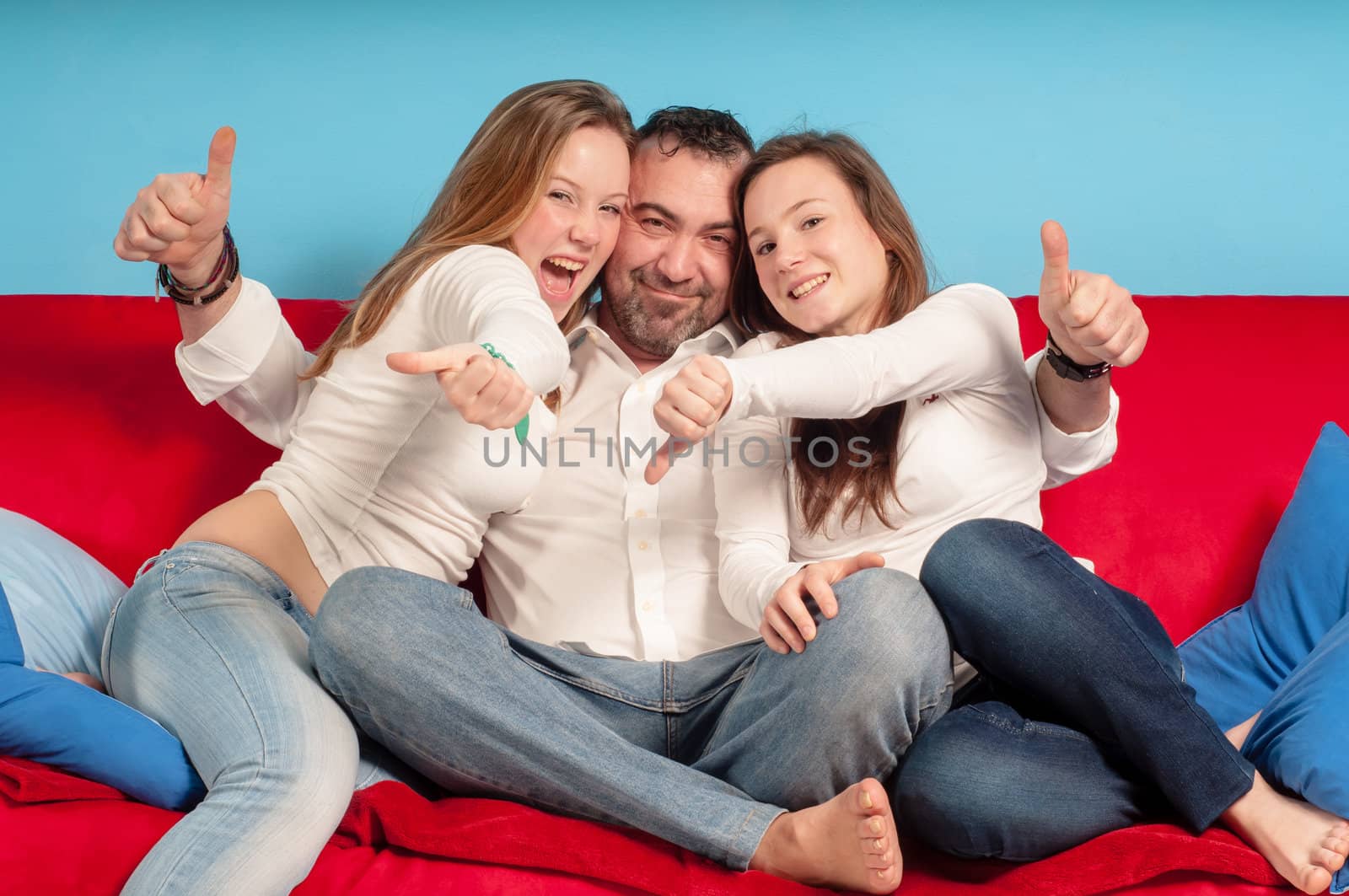 happy father and daughters on the couch by peus