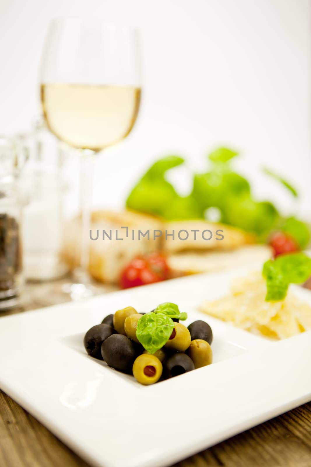 deliscious antipasti plate with parma parmesan olives on wooden background