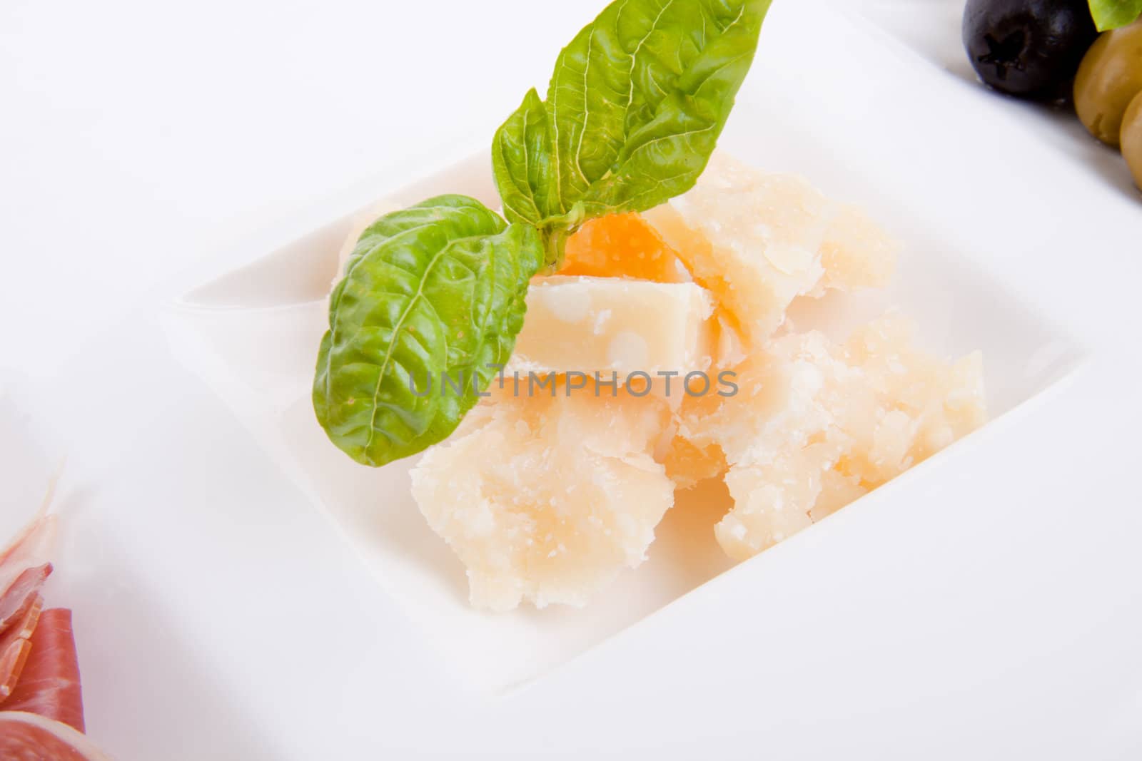 deliscious antipasti plate with parma parmesan and olives isolated on white background