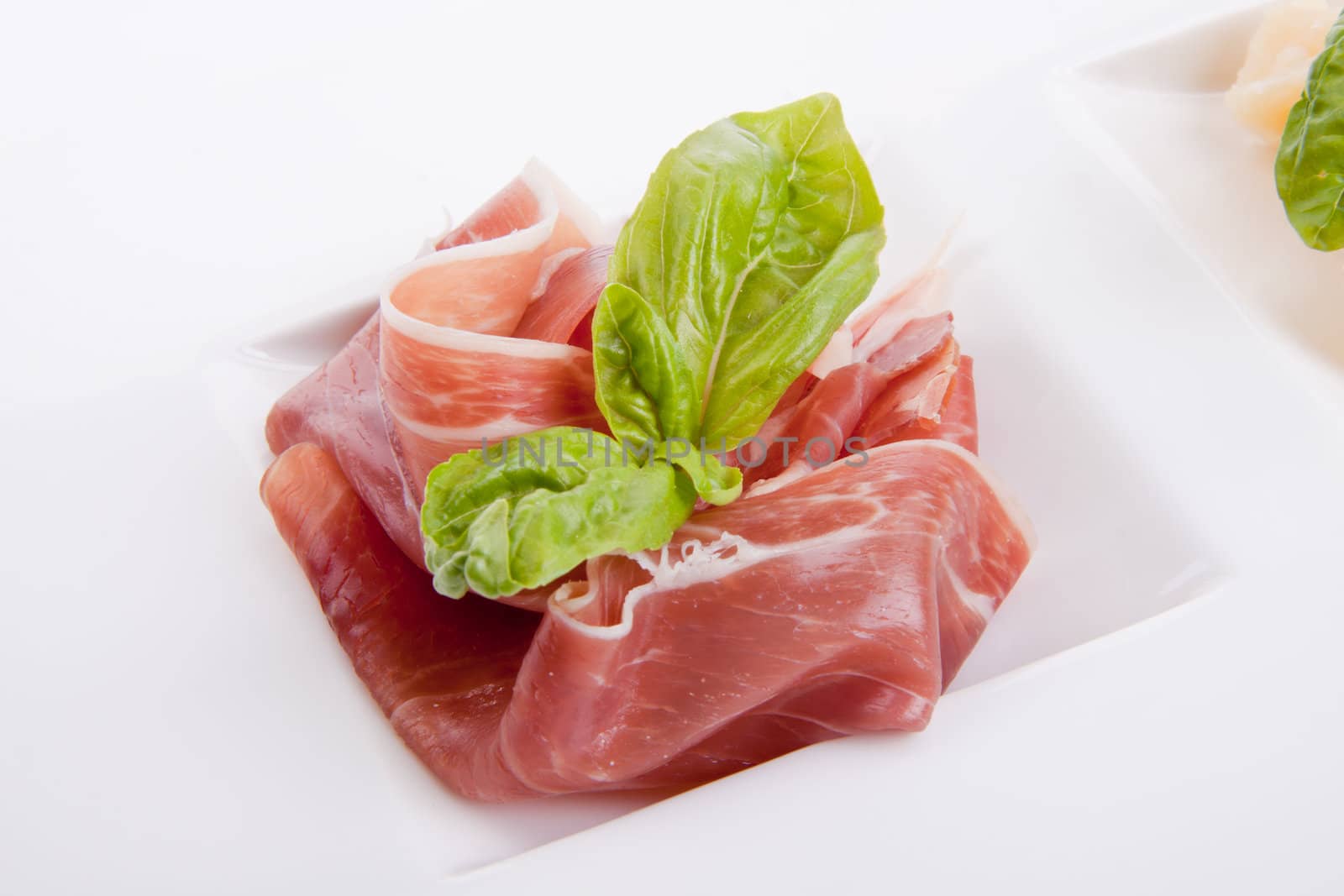 deliscious antipasti plate with parma parmesan and olives isolated on white background