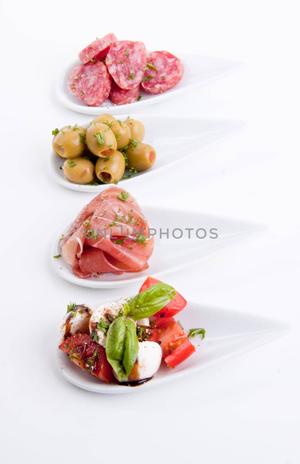 deliscious antipasti plate with parma parmesan and olives isolated on white background