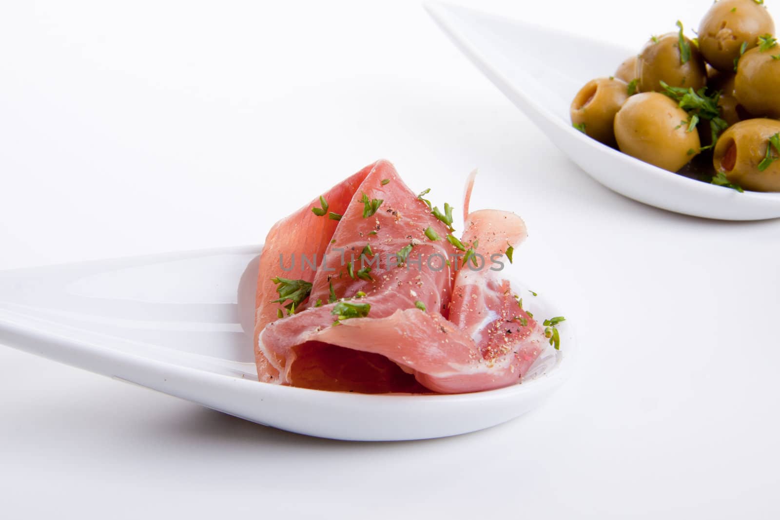 deliscious antipasti plate with parma parmesan and olives isolated on white background