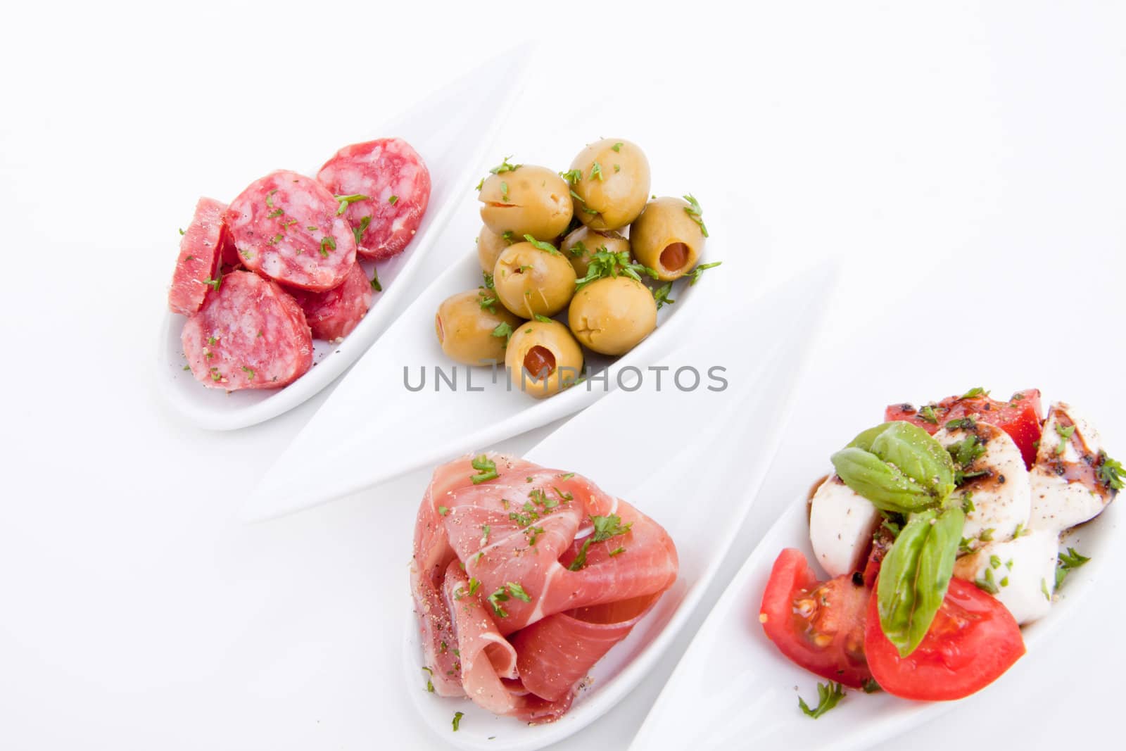 deliscious antipasti plate with parma parmesan and olives isolated on white background