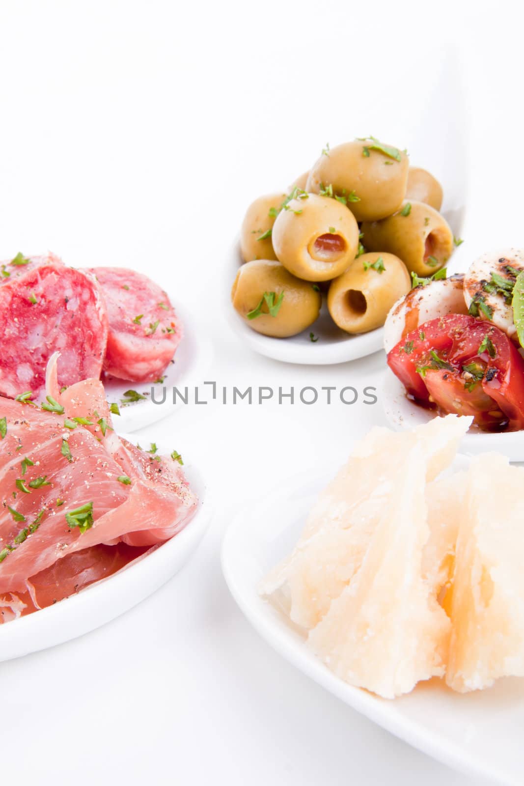 deliscious antipasti plate with parma parmesan and olives isolated on white background