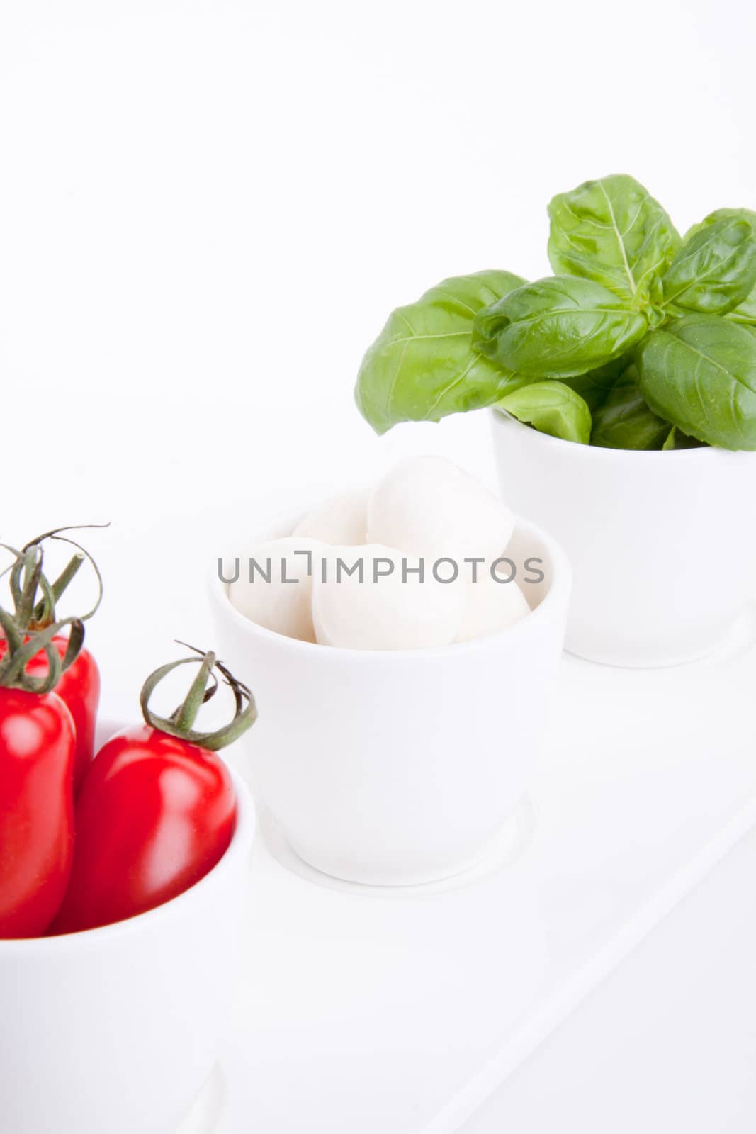 tasty tomatoe mozarella salad with basil isolated on white background