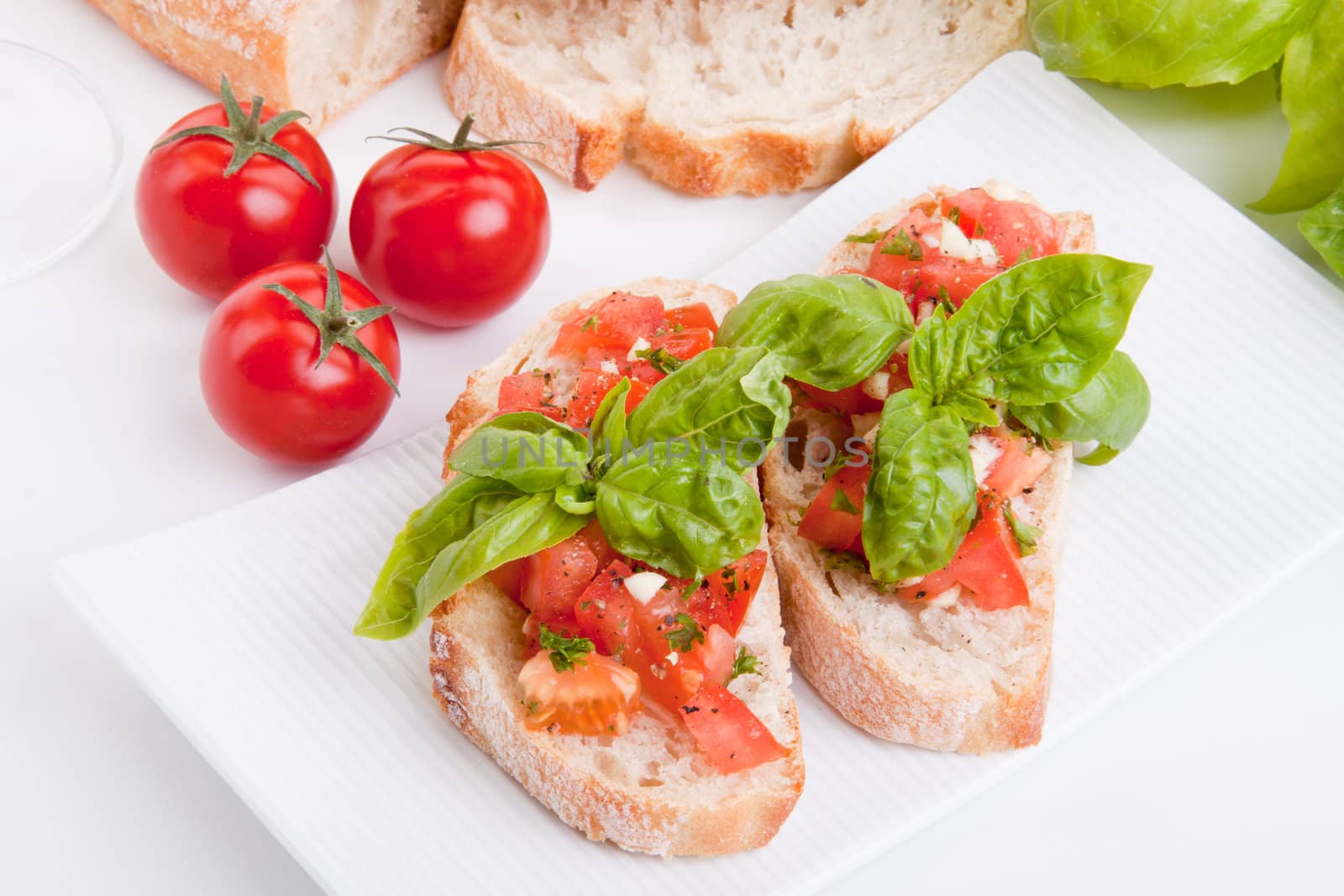 deliscious fresh bruschetta appetizer with tomatoes isolated on white background