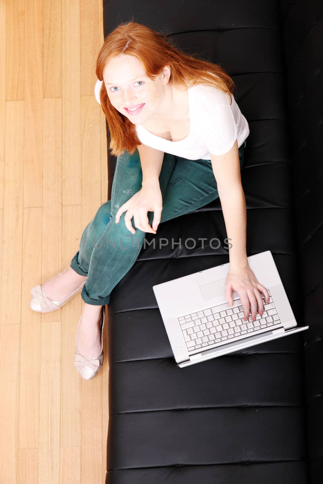 A young, brazilian woman surfing on the Internet with a Laptop.  