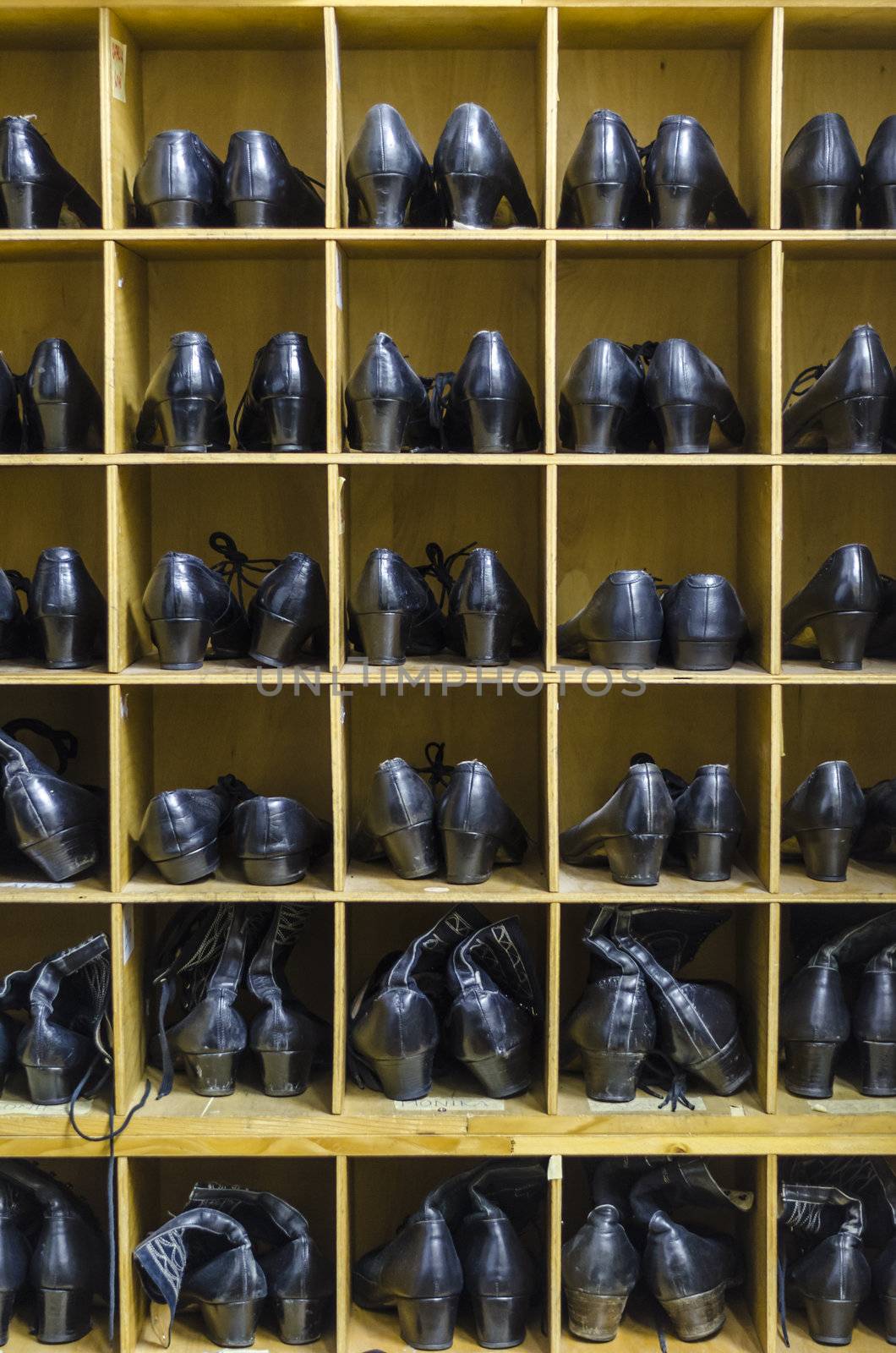 Old folkloristic dancing boots organised in trays.