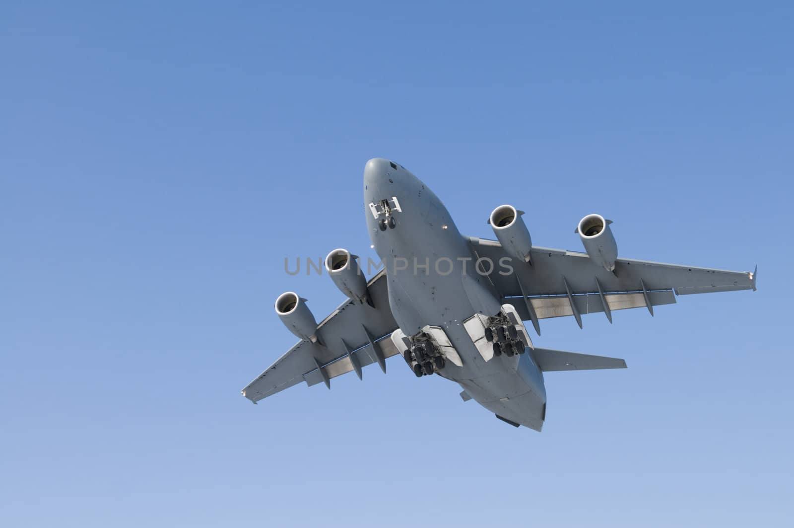 Military Transport Plane coming in for a landing - with copy space blue sky.