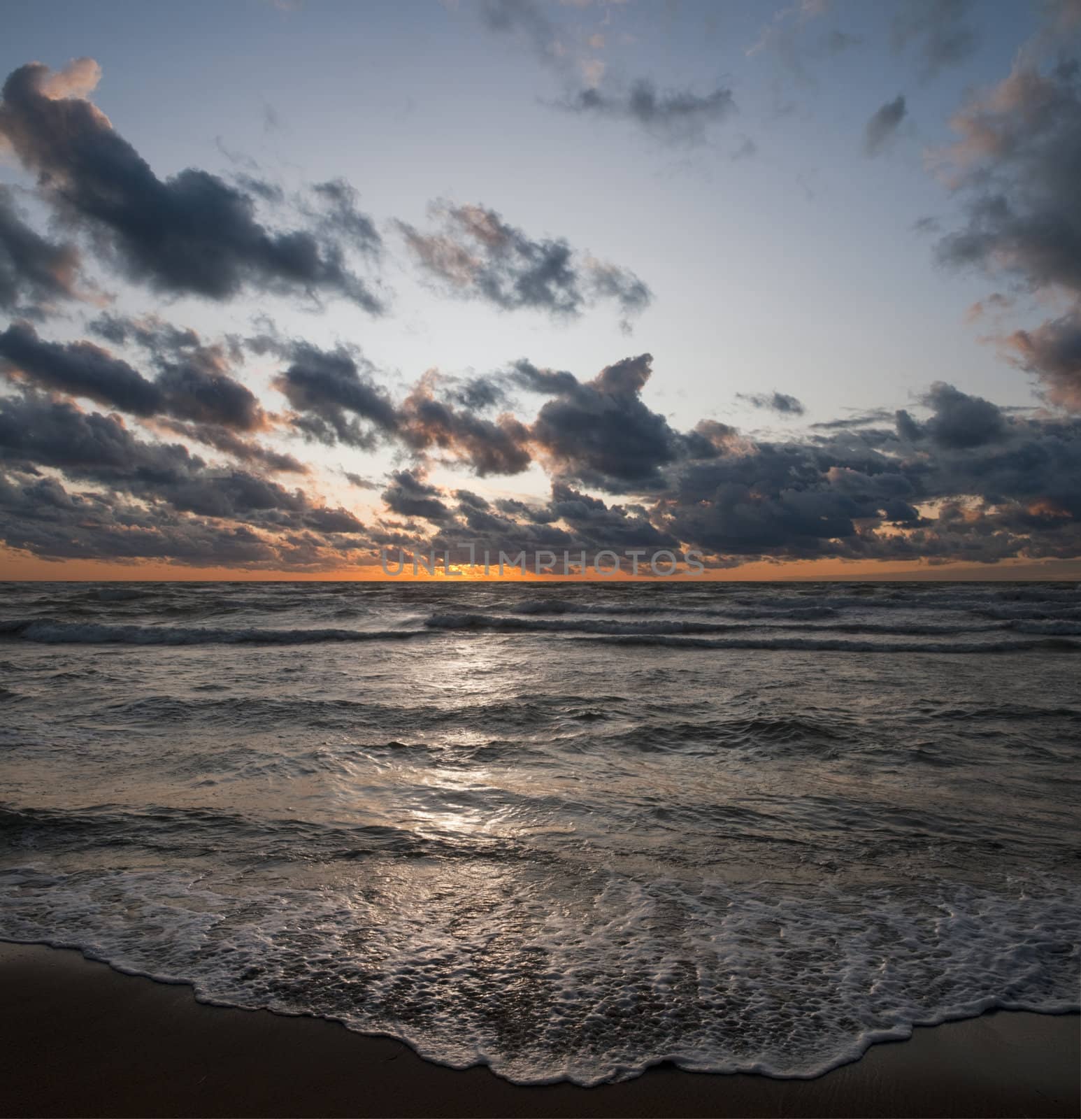 Vertical panaroma created with two horizontals placed on top of each other - one mostly sky and the other ocean
