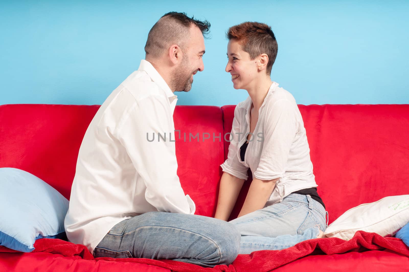 husband and wife hugging on the couch in the living room