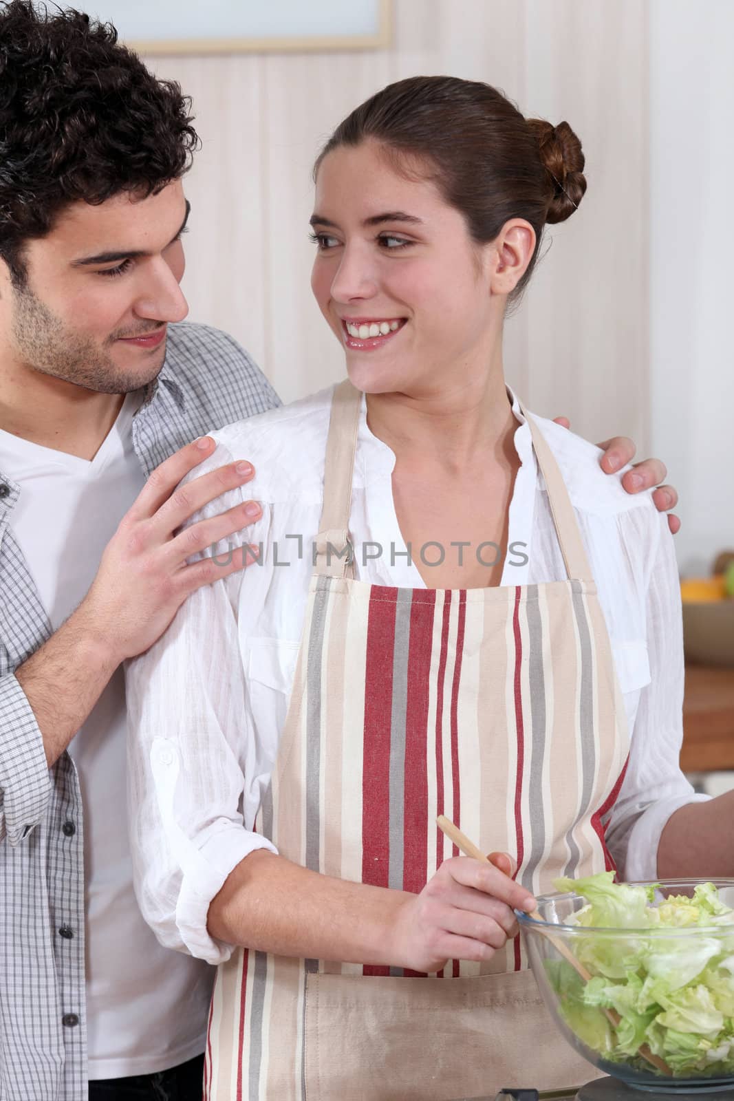 Couple mixing salad by phovoir