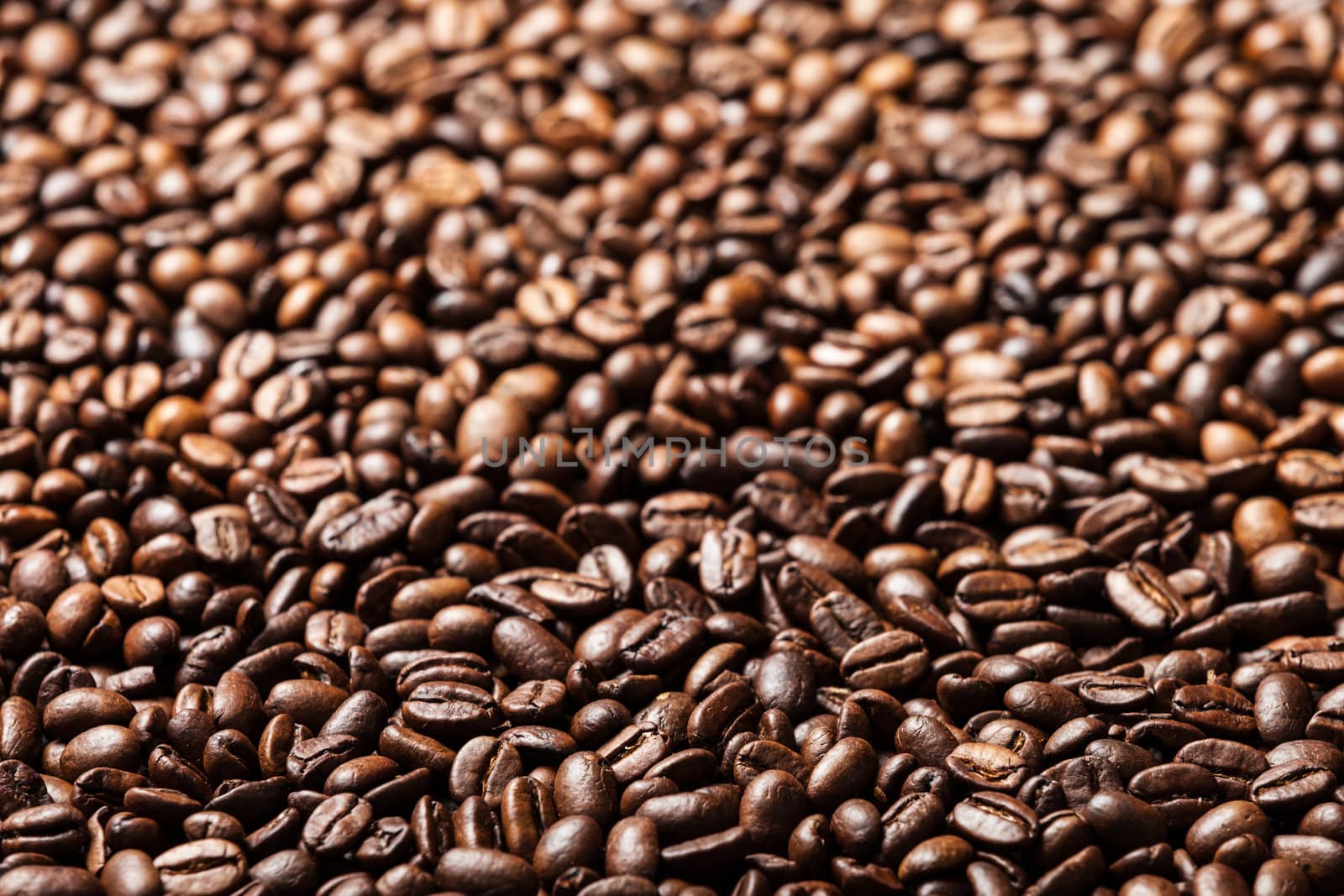 Brown roasted raw coffee bean heap background