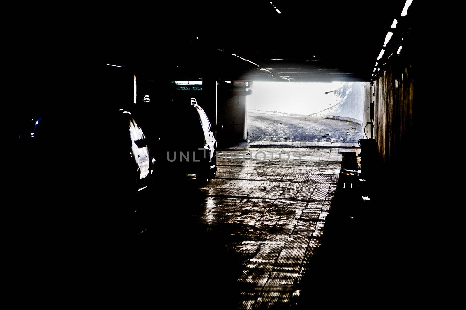 Generic photograph of daylight coming between the dark shadows of an under ground vehicle parking facility in Bombay, India