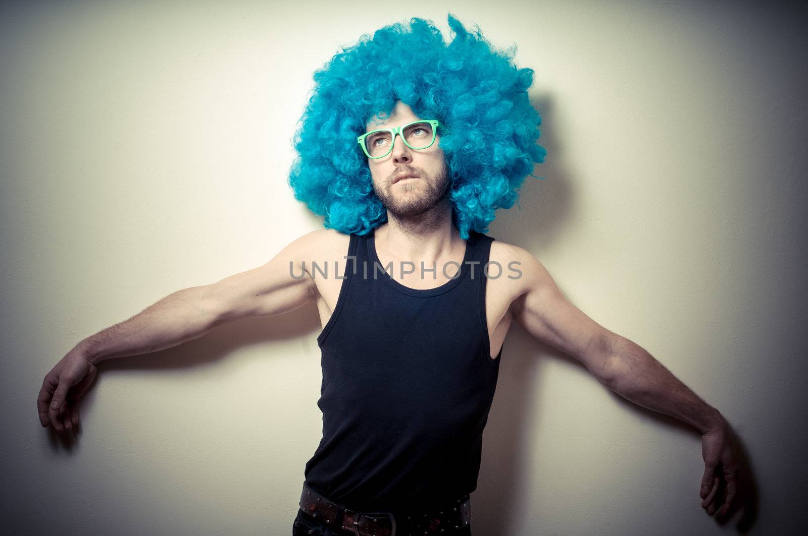 vintage portrait of fashion guy with blue wig on gray background