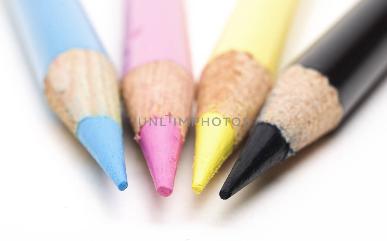 Macro photo CMYK colour pencils with selective focus on the sharp end