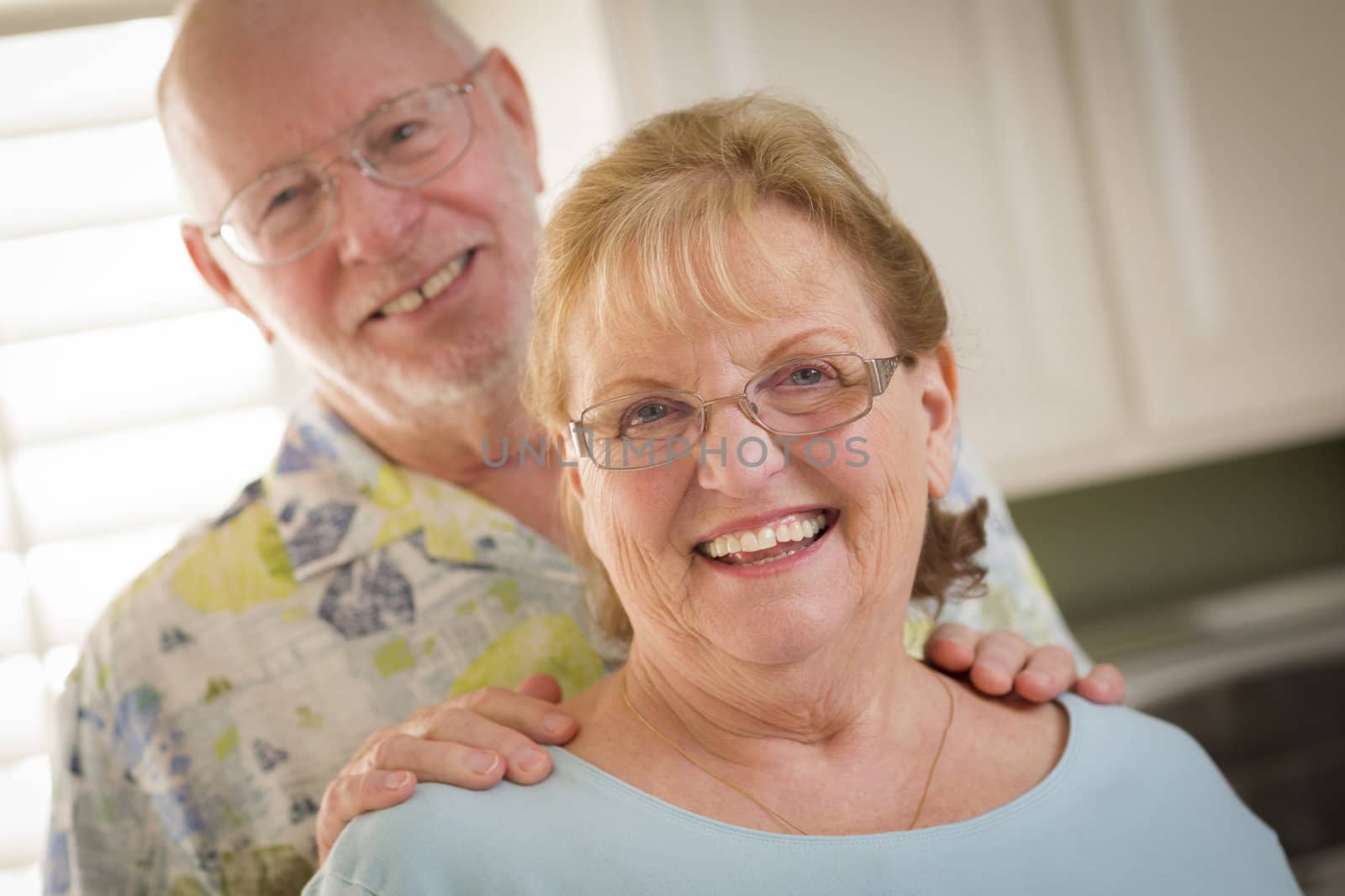 Happy Caucasian Senior Couple Portrait Inside by Feverpitched