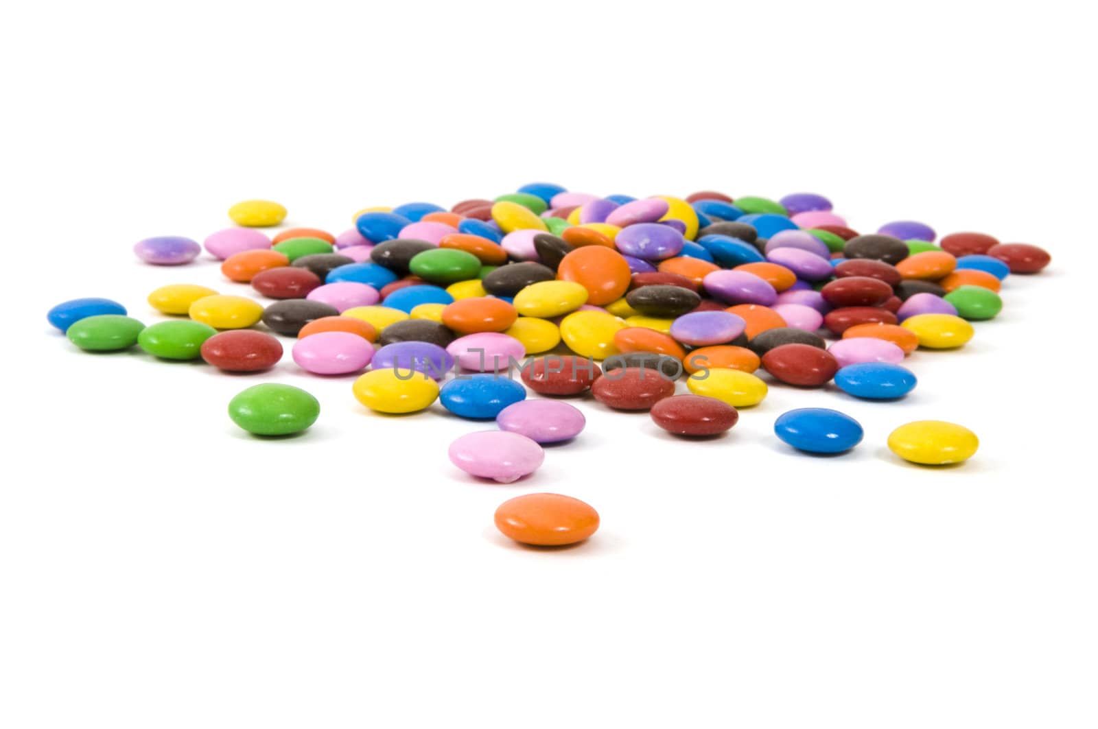 Multi colored chocolate candy on white background