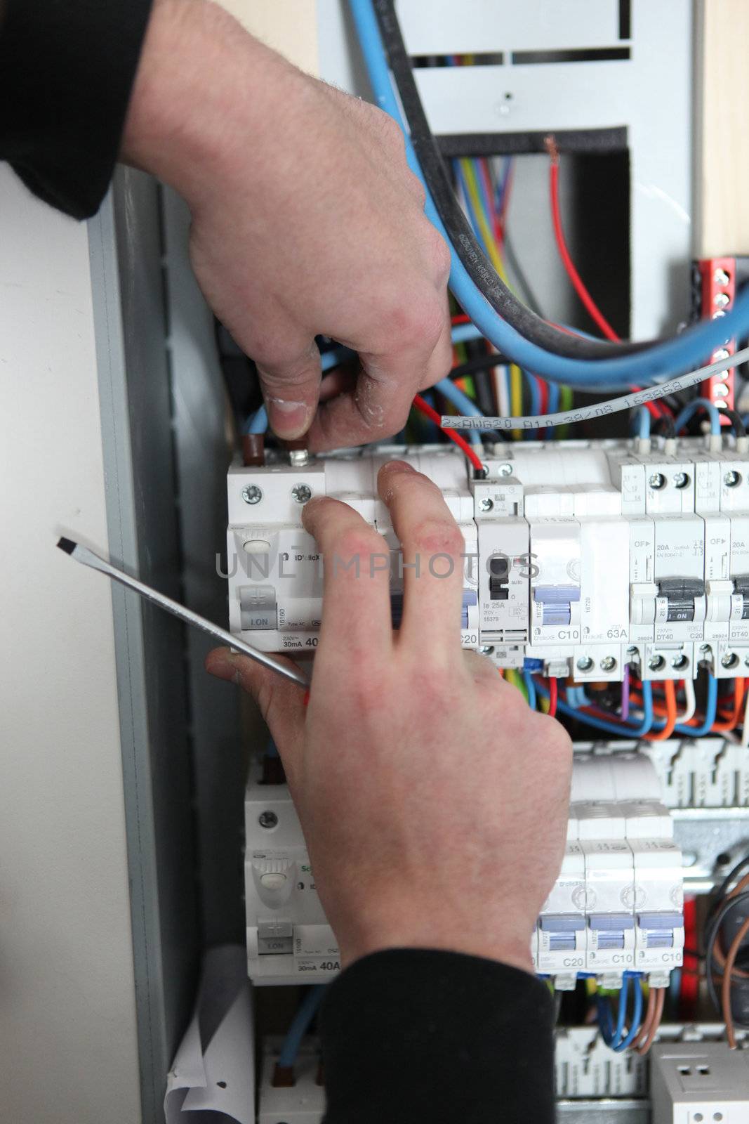 Man at a fuse box by phovoir